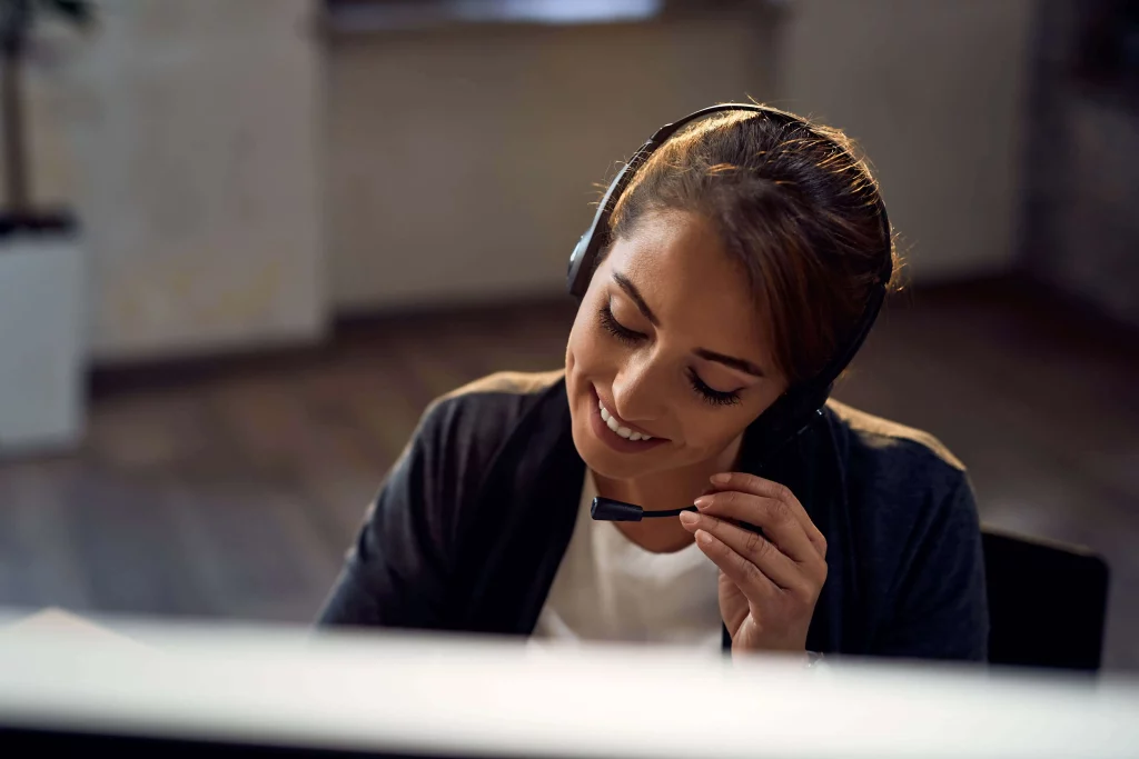 female-customer-service-representative-communicating-headset-while-working-office-min